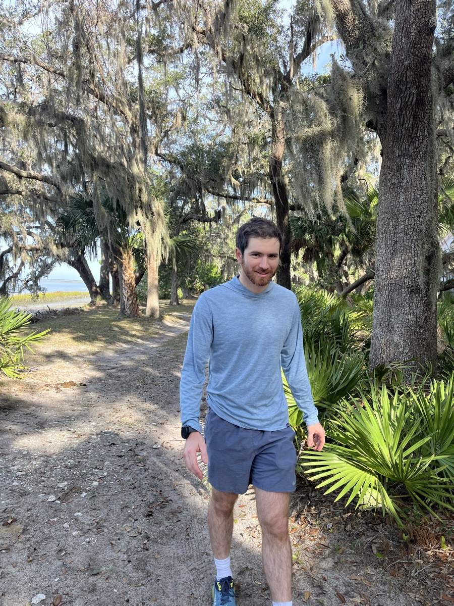 Ledyard walking a sandy path beneath curtains of Spanish moss and palmettos