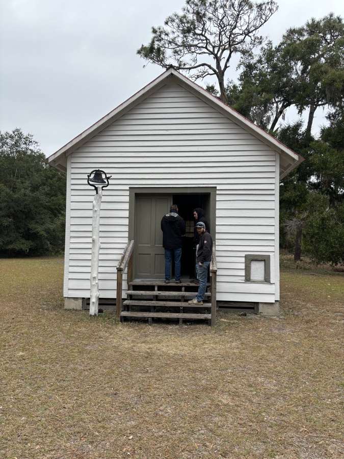 The family on the steps of the little white First African Baptist Church
